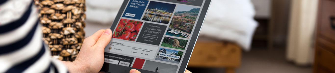 Women looking at a webpage on a tablet.