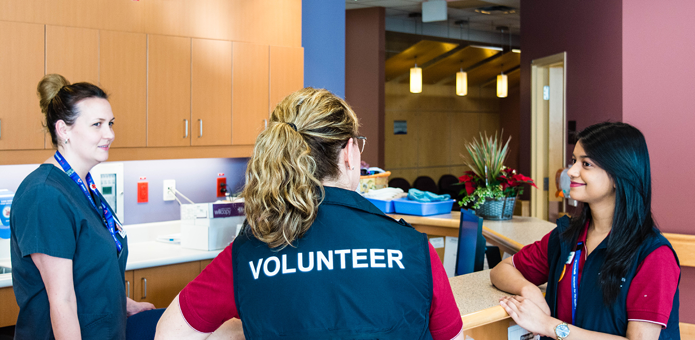 Three volunteers at info desk