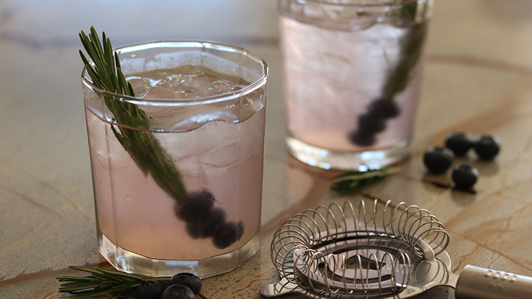 Two blueberry mocktails in medium sized glasses