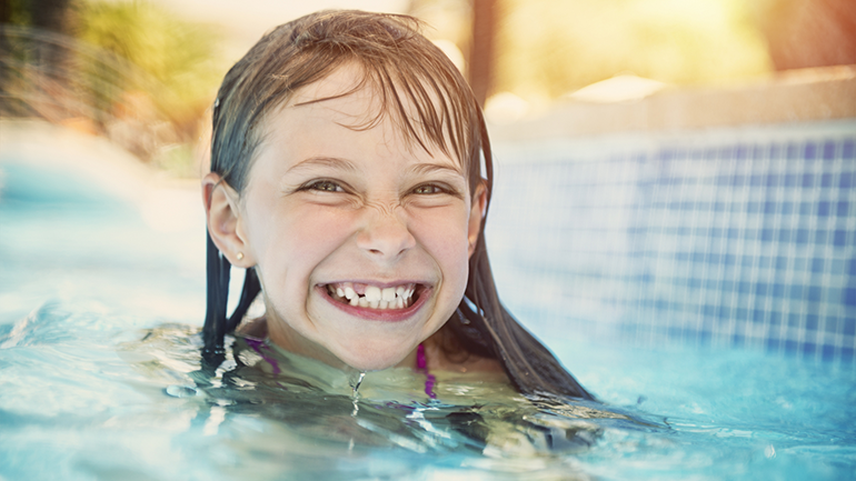 Girl smiling in swimming pool