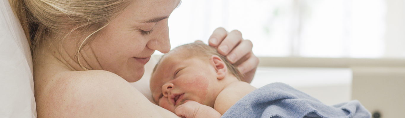 Mother holding baby after delivery