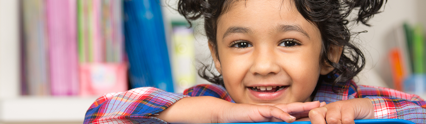 Young kindergarten girl in pigtails