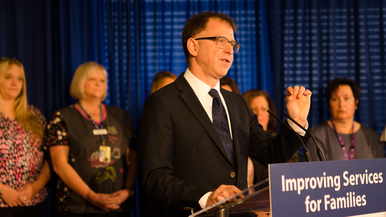 Minister of Health, Adrian Dix, speaking at podium