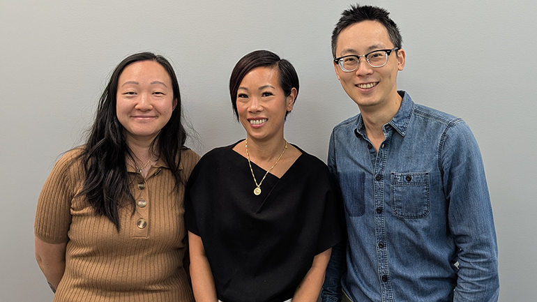 Group photo of three people, two female presenting, one male presenting.