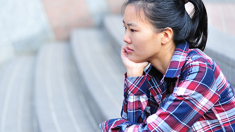 Woman sitting on the stairs thinking