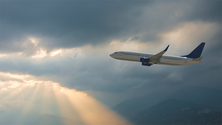 Airplane flying by the clouds