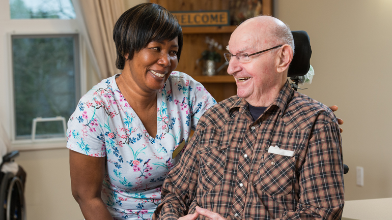 Nurse and senior smiling at each other