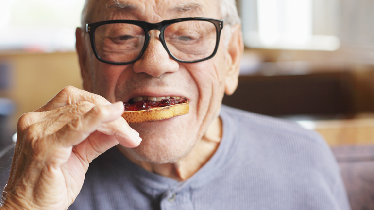 Elder eating toast