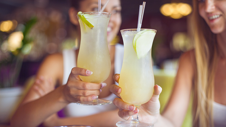 Two girls having a cold drink at a restaurant
