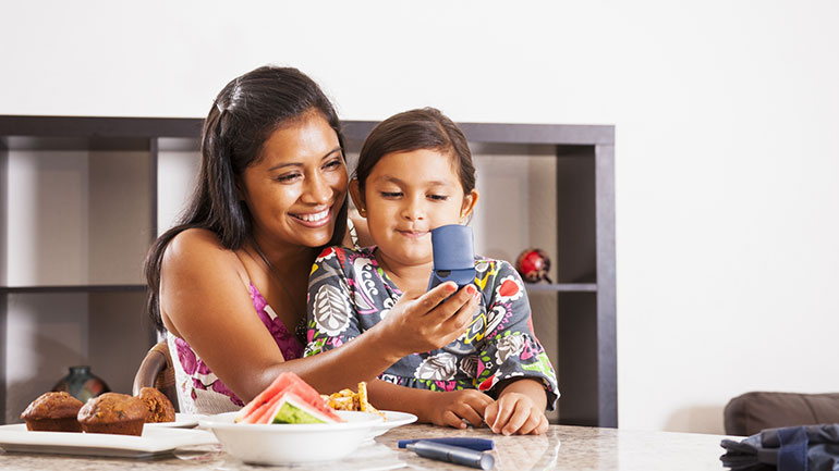 Mother and daughter sitting together at a dining table