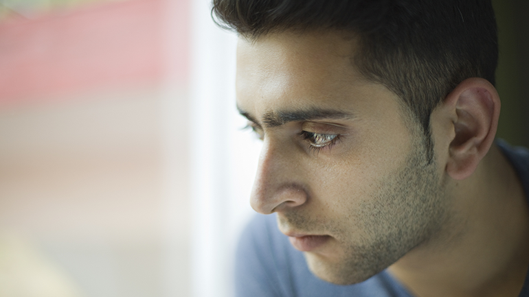 Close up of a man looking outside the window