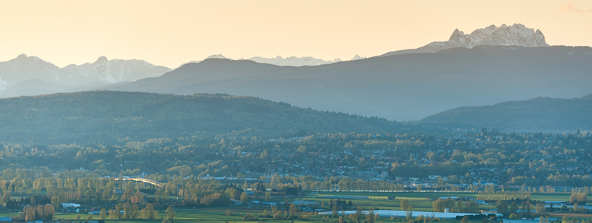 Mission mountains in the distance from the fields of Matsqui at golden hour