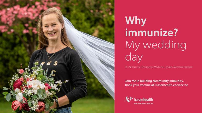Woman wearing a bridal veil and holding a floral bouquet.
