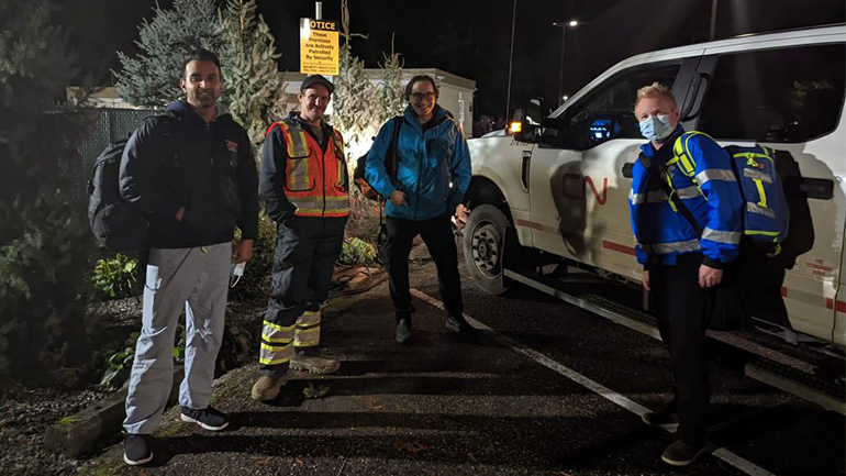 Sumeet Gill, respiratory therapist, Tyson, CN Rail employee, Dr. Greg Haljan, critical care physician and medical director, Greg Sills, critical care nurse standing outside in a parking lot during the night