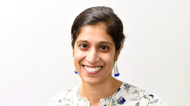 Image of woman posed against backdrop.