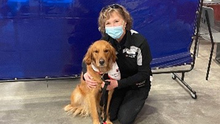 Woman standing with dog.