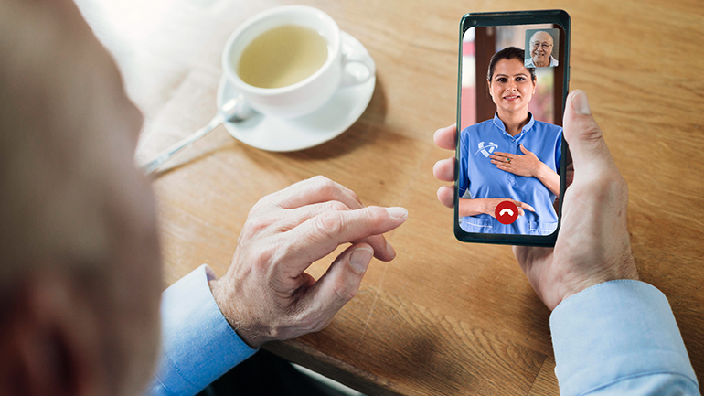 Person speaking with a health care worker on a mobile video call