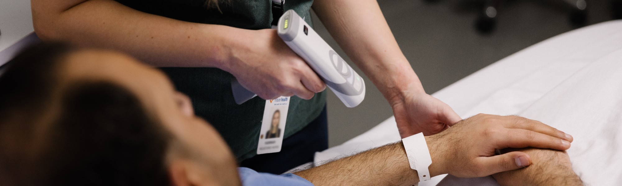 nurse uses a scanner on patient wristband
