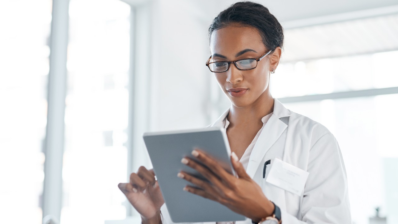 Physician scrolling on a tablet