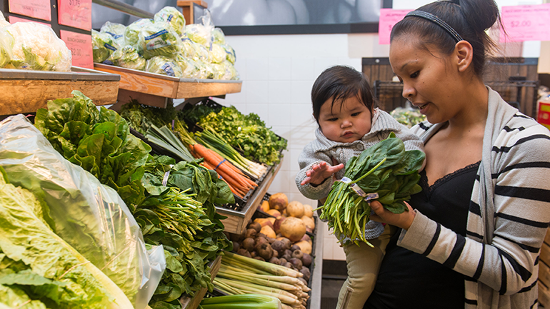 Aboriginal woman with baby daughter at produce store