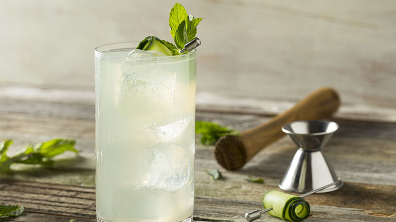 A coconut, cucumber, lime and mint cooler in a tall glass
