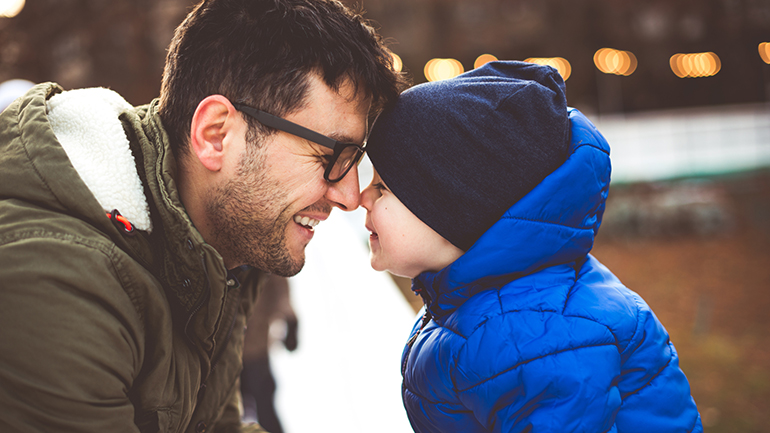Father and son at ice skating rink