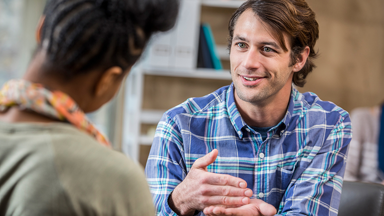 Image of male counsellor speaking with individual