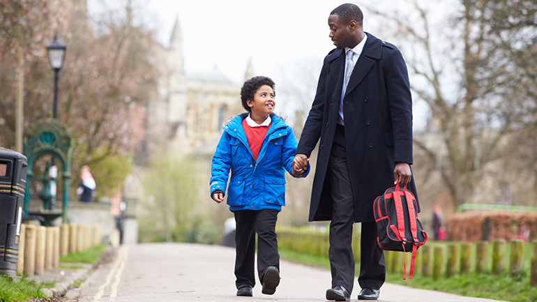Father and son walk to school