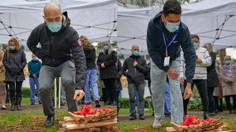 (Left) Arthur Pangilinan, manager, Volunteer Resources, Burnaby Hospital and (right) Sameer Vohra, manager, Operating Room, Burnaby Hospital placing small pouches of tobacco on top of the fire.