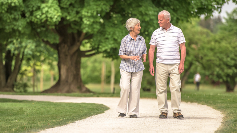 Seniors talking to each other while walking at a park