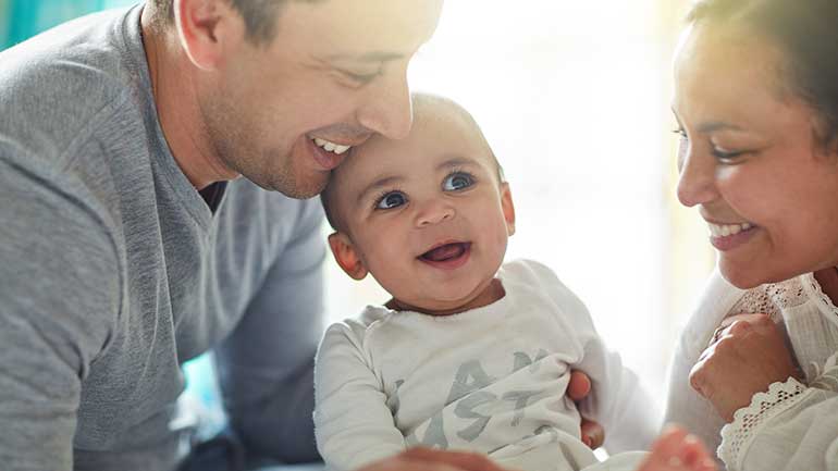 Parents playing with their baby