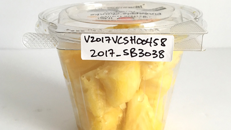 Pineapple chunks in a plastic cup