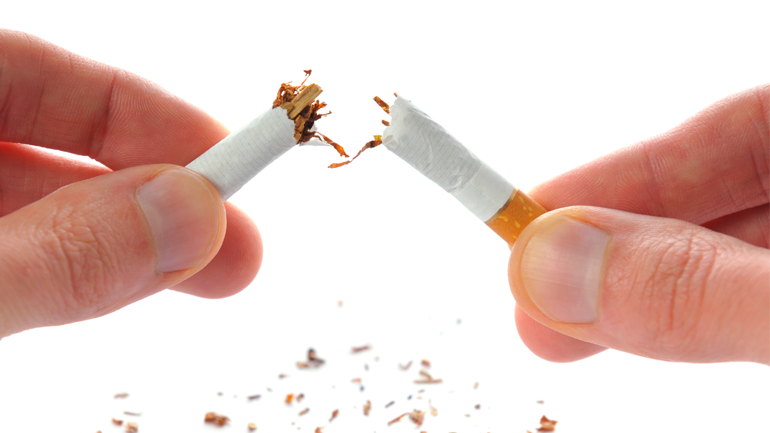 Hands holding a cigarette that snapped in half