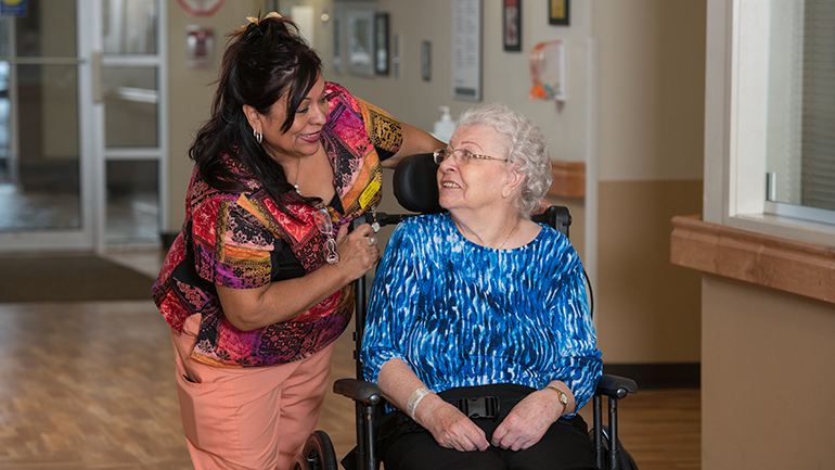 Nurse talking to a senior in a wheelchair