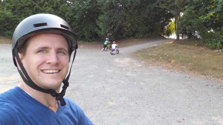 A dad biking with his kids