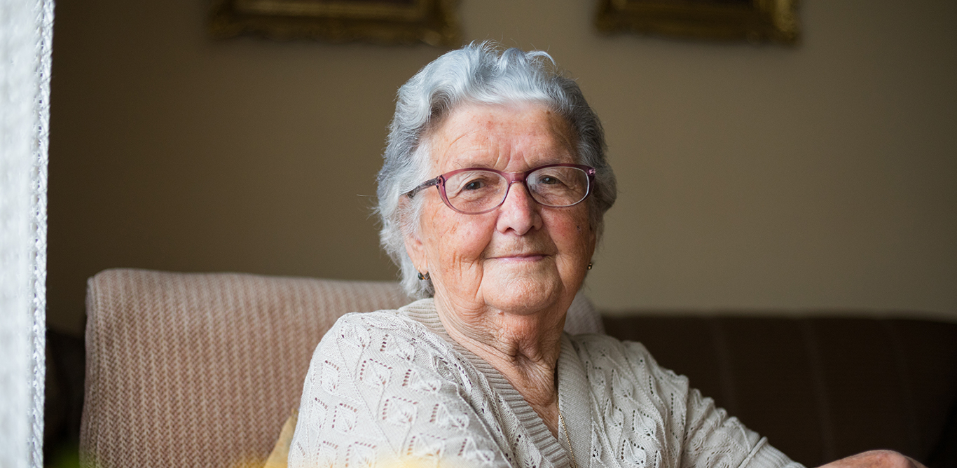 Elder lady sitting and smiling