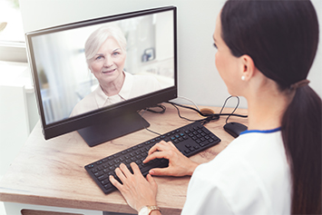 health care worker talking to patient over video call