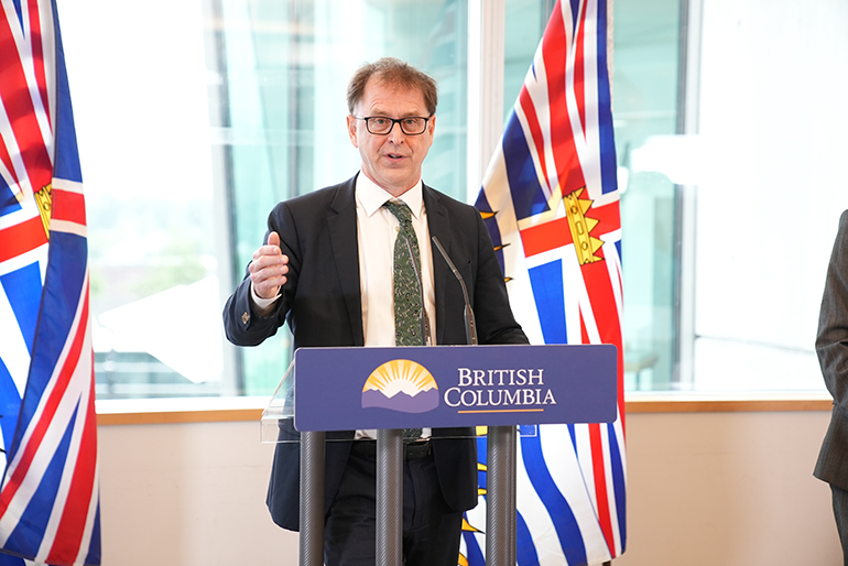 Minister Dix speaking at podium