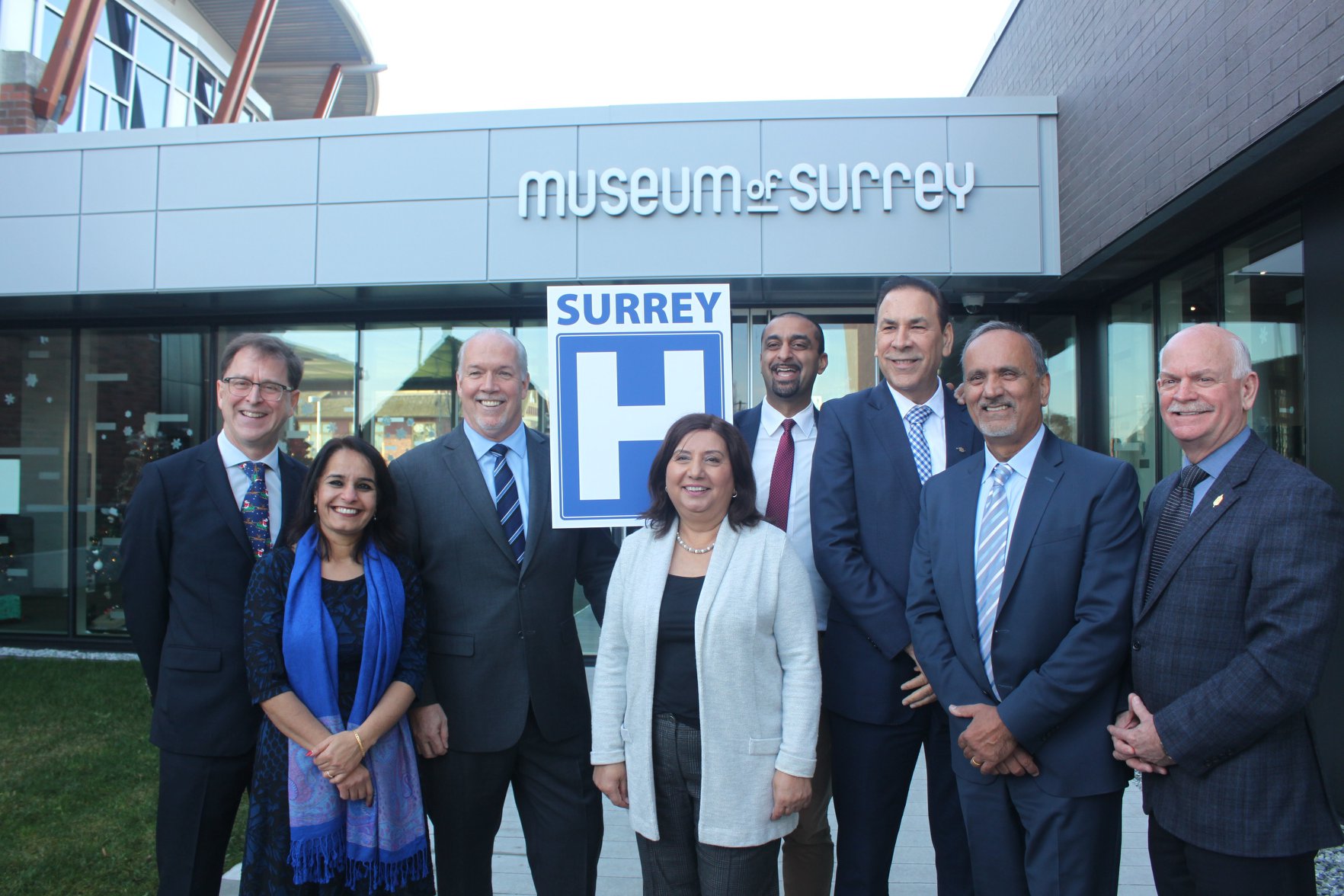 Group photo of Minister Dix and Premier Horgan, joined by Surrey MLAs at Museum of Surrey. 