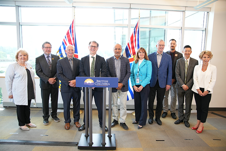 Group of 10 people standing behind podium