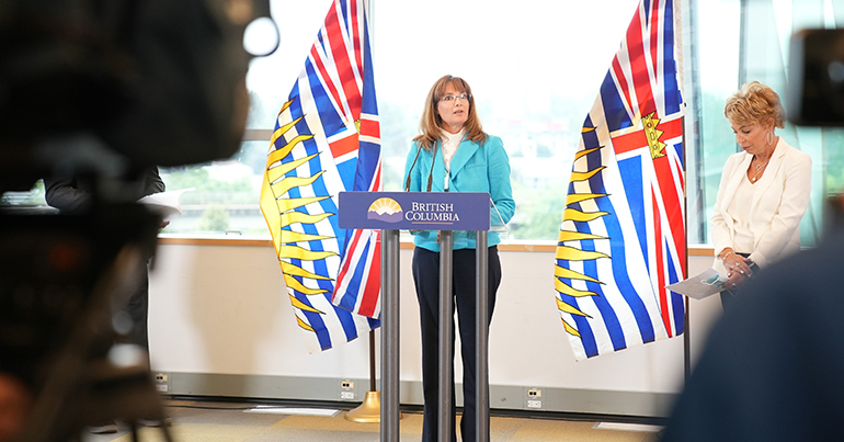 Laurie Leith speaking at podium