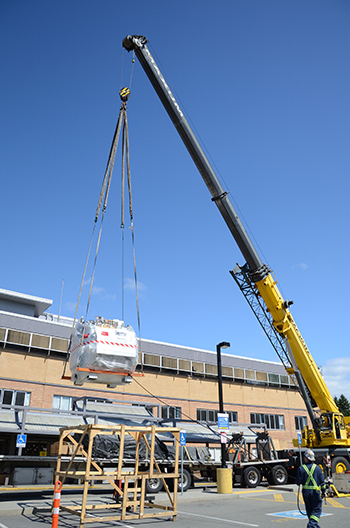 11 thousand pound MRI magnet being carefully hoisted by the crane