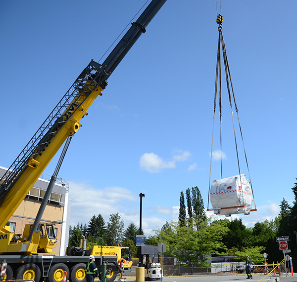 11 thousand pound MRI magnet being carefully hoisted by crane
